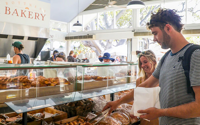Customers selecting pastries at Rottnest Island bakery.