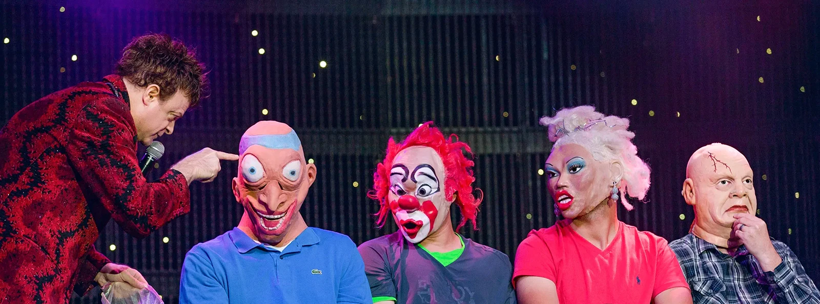Performer interacting with masked participants at V - The Ultimate Variety Show.