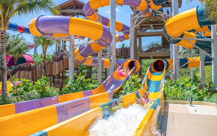 Water slide at Andamanda Phuket with people enjoying the ride.