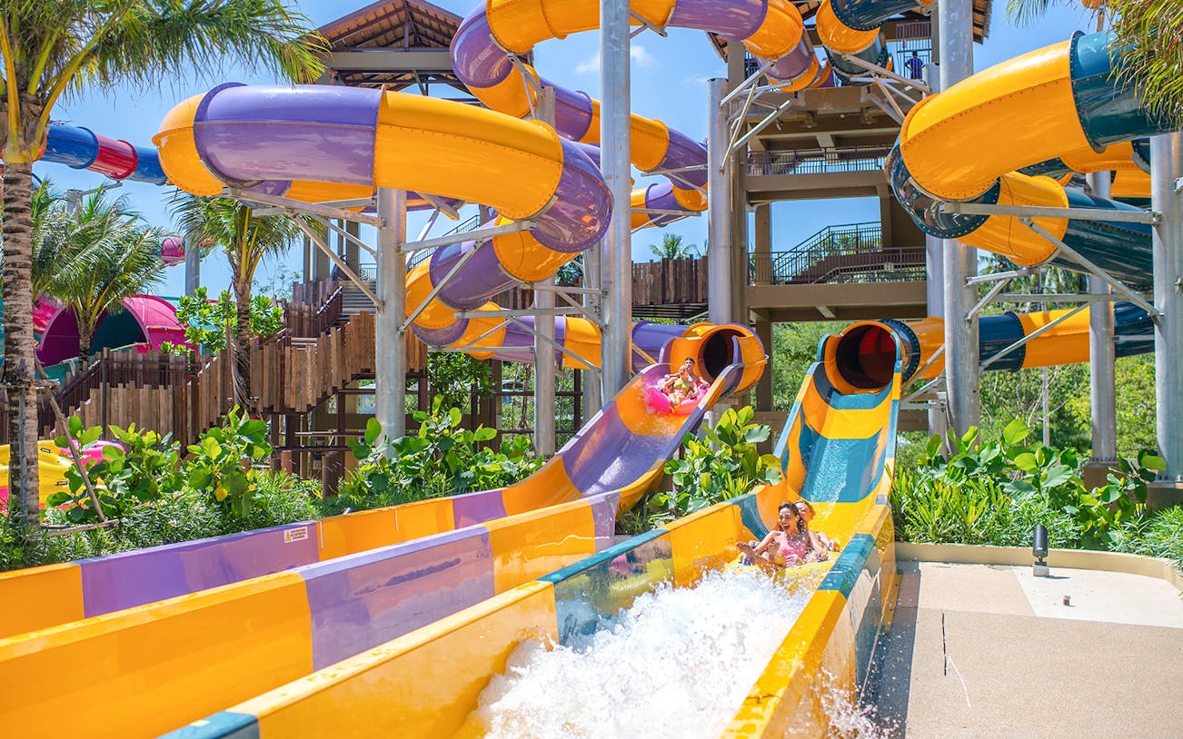 Water slide at Andamanda Phuket with people enjoying the ride.