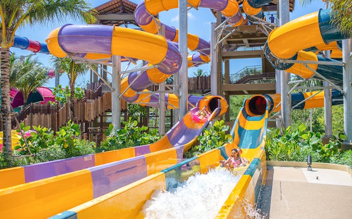 Water slide at Andamanda Phuket with people enjoying the ride.