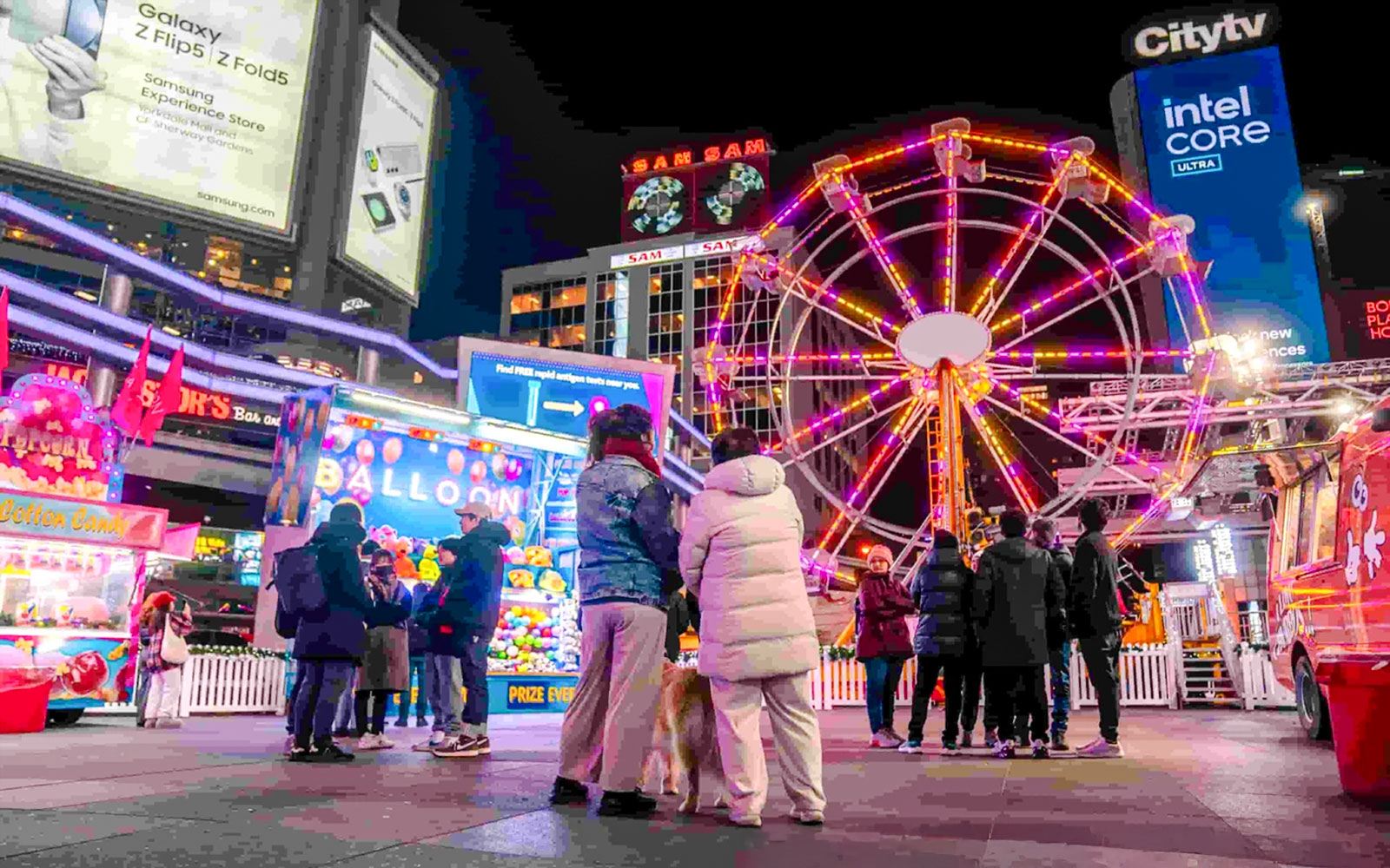 Ferris wheel and festive crowd at Winter Glow event, Sankofa Square.