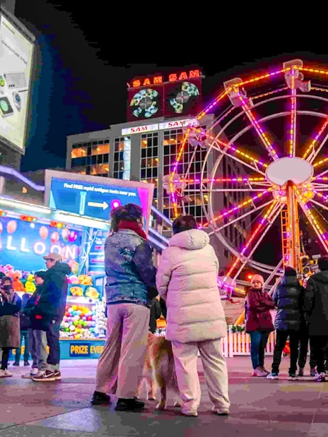 Ferris wheel and festive crowd at Winter Glow event, Sankofa Square.