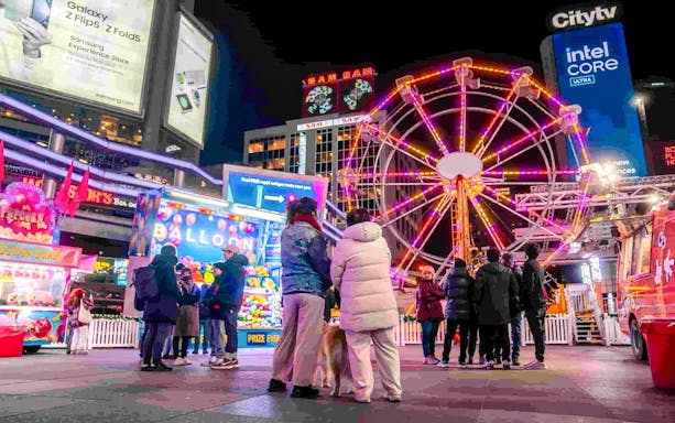 Ferris wheel and festive crowd at Winter Glow event, Sankofa Square.
