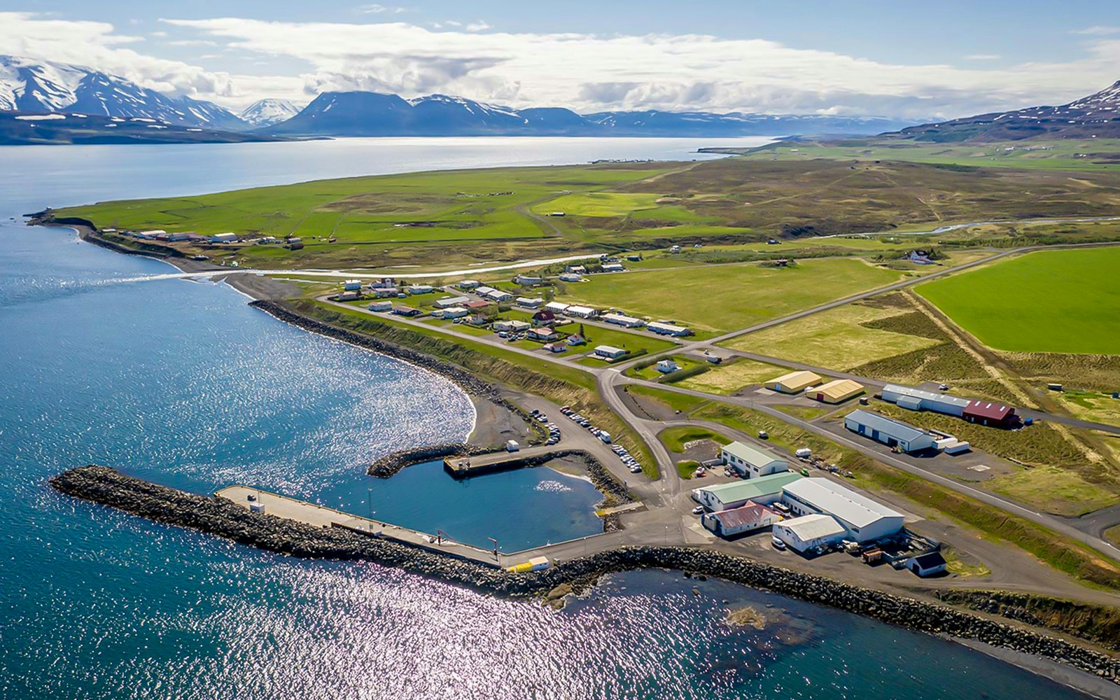 Aerial view of Eyjafjörður village with coastline and surrounding fields in Iceland.