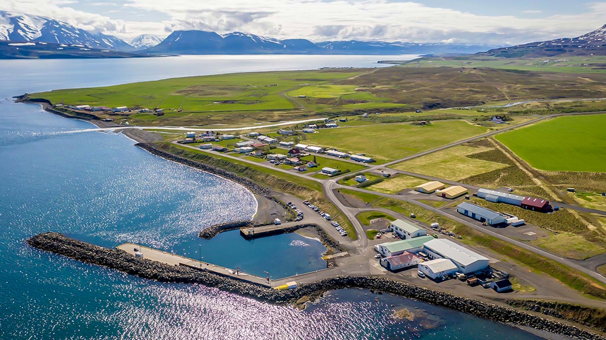 Aerial view of Eyjafjörður village with coastline and surrounding fields in Iceland.