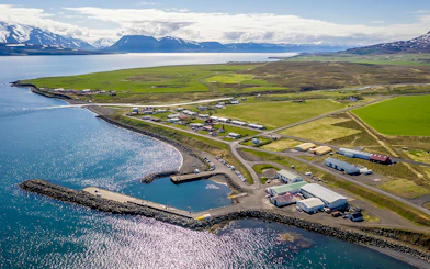 Aerial view of Eyjafjörður village with coastline and surrounding fields in Iceland.