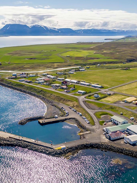Aerial view of Eyjafjörður village with coastline and surrounding fields in Iceland.