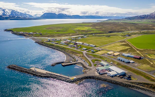 Aerial view of Eyjafjörður village with coastline and surrounding fields in Iceland.