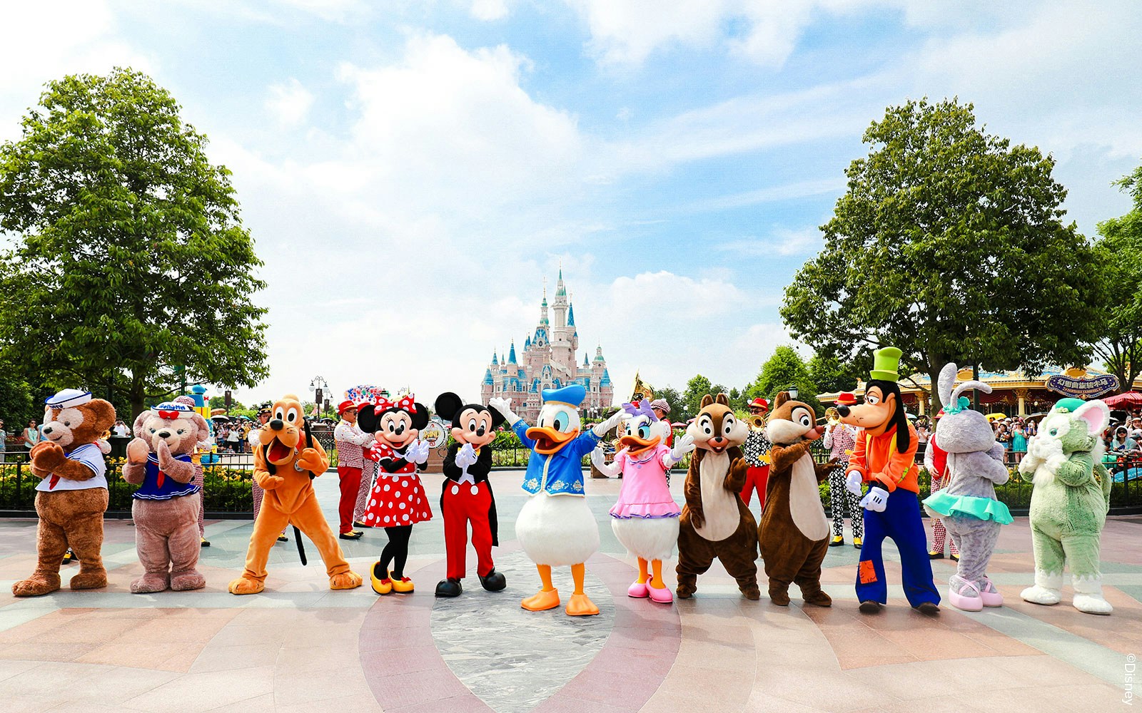 Characters in front of Enchanted Storybook Castle at Shanghai Disneyland.