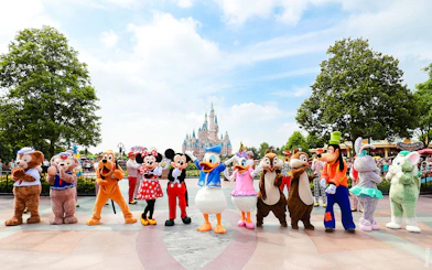 Characters in front of Enchanted Storybook Castle at Shanghai Disneyland.