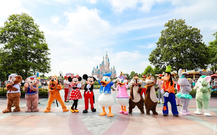Characters in front of Enchanted Storybook Castle at Shanghai Disneyland.