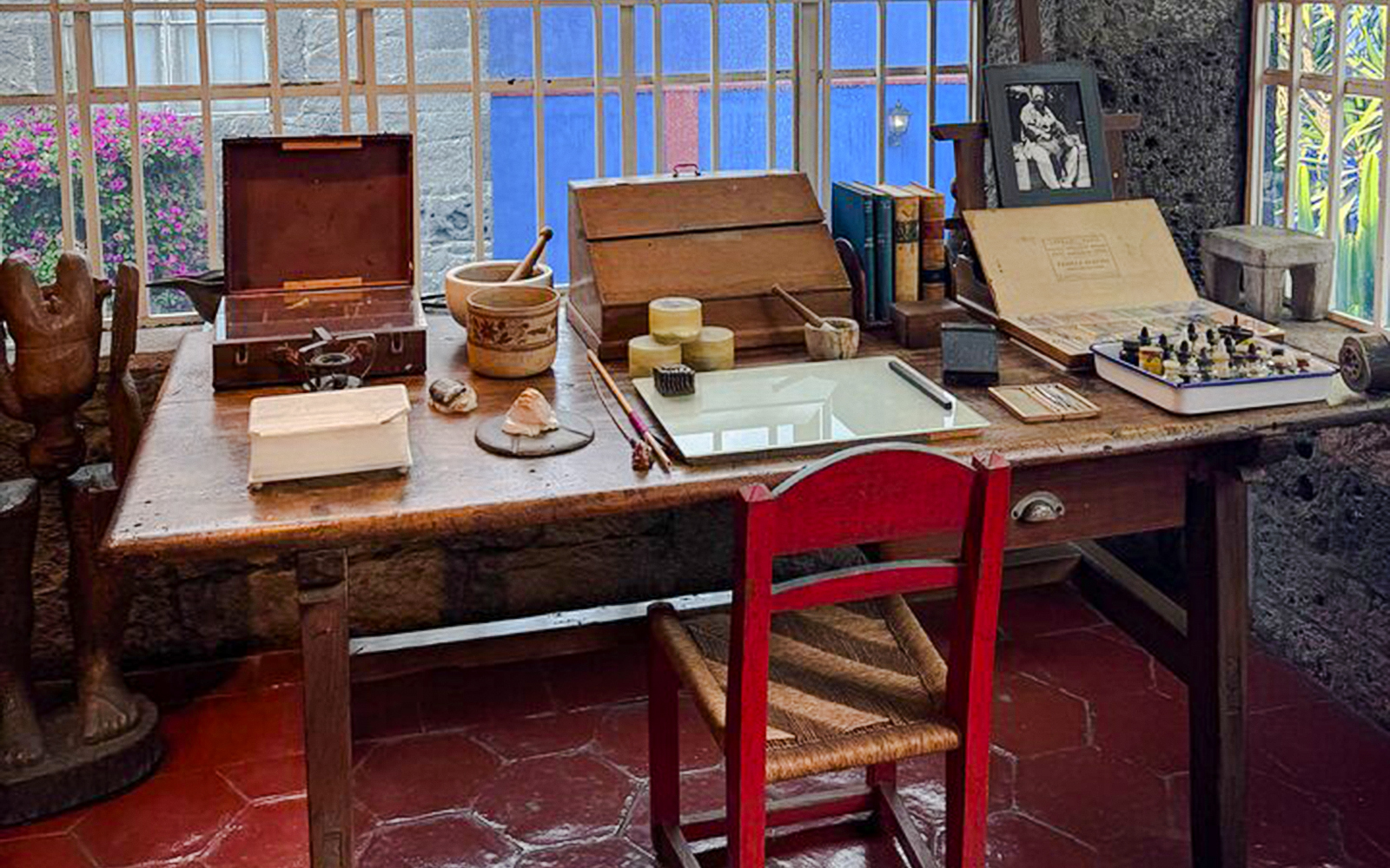 Frida Kahlo Museum desk with art supplies and books in Mexico City.
