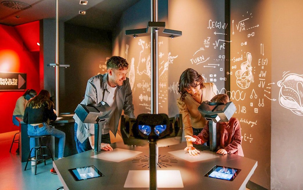 Guests interacting with exhibits inside Haus der Musik, Vienna.