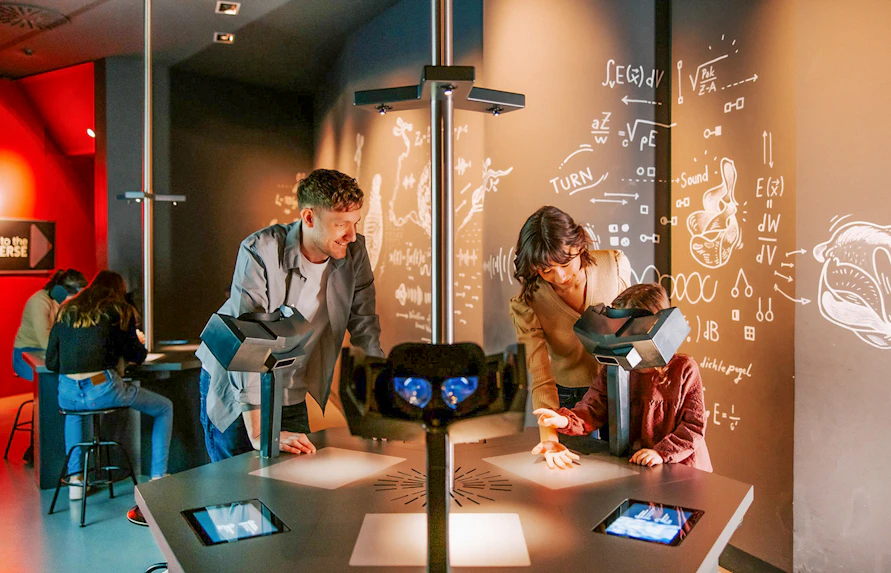 Guests interacting with exhibits inside Haus der Musik, Vienna.