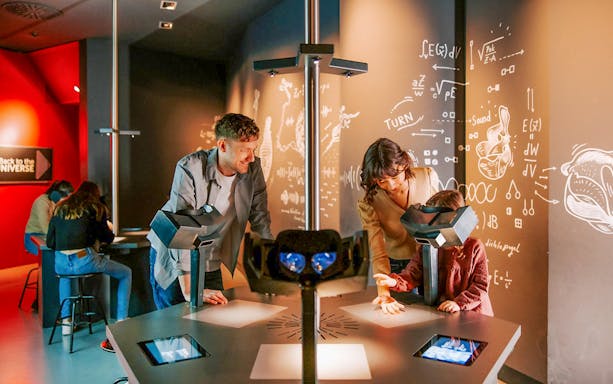 Guests interacting with exhibits inside Haus der Musik, Vienna.