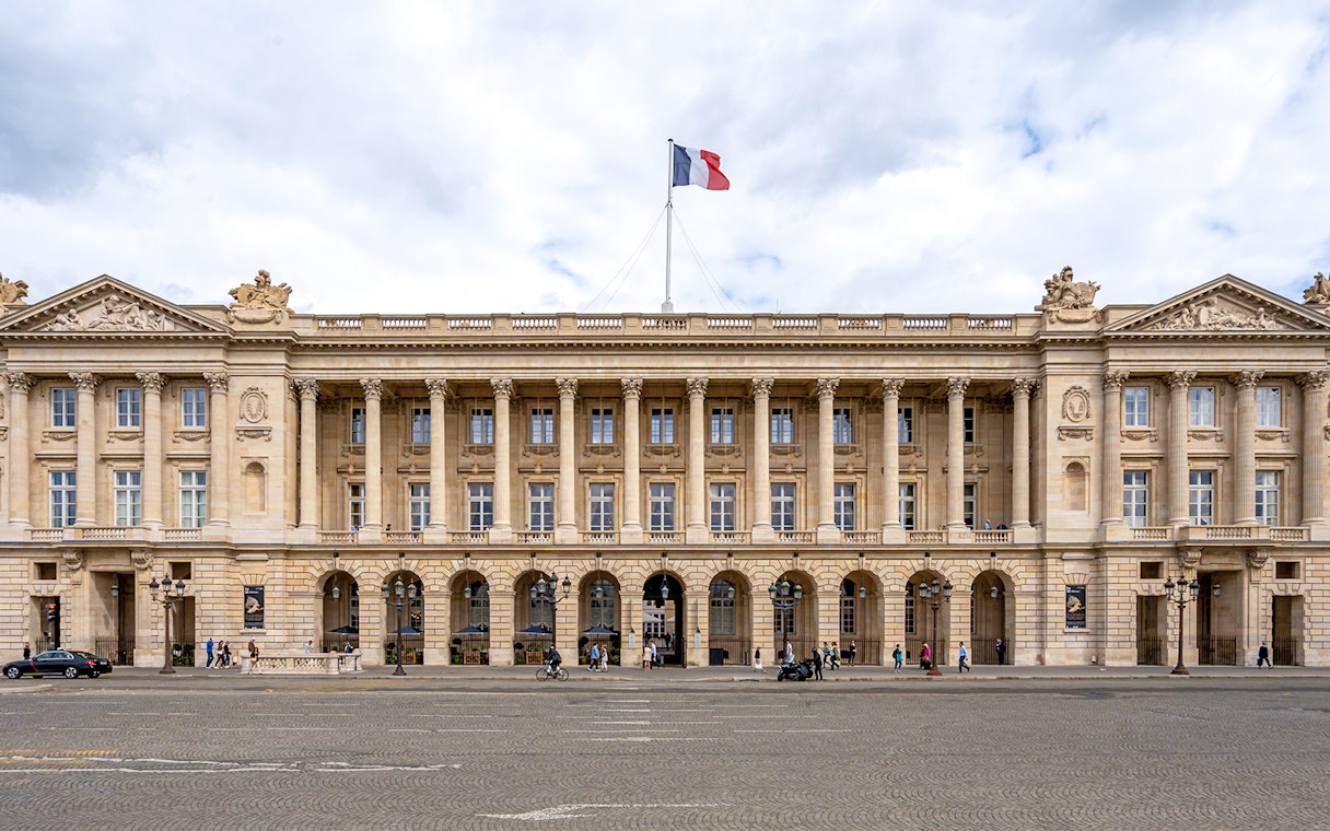 Hôtel de la Marine facade with French flag, Paris.