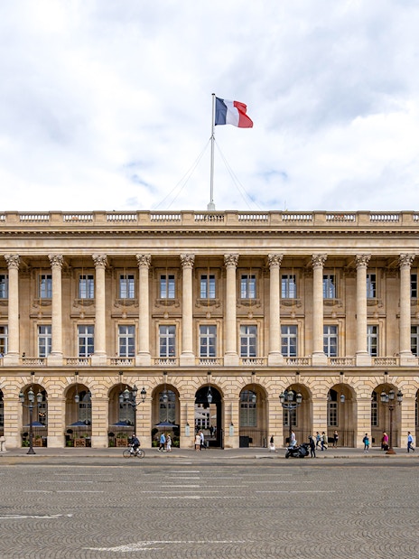 Hôtel de la Marine facade with French flag, Paris.
