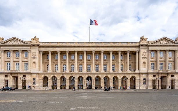 Hôtel de la Marine facade with French flag, Paris.