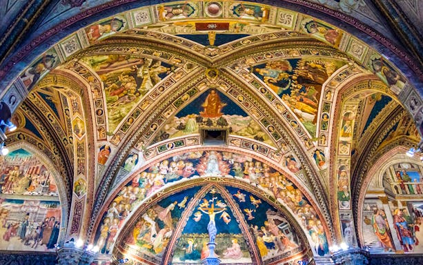 Frescoed ceiling of Siena Cathedral depicting religious scenes, Italy.