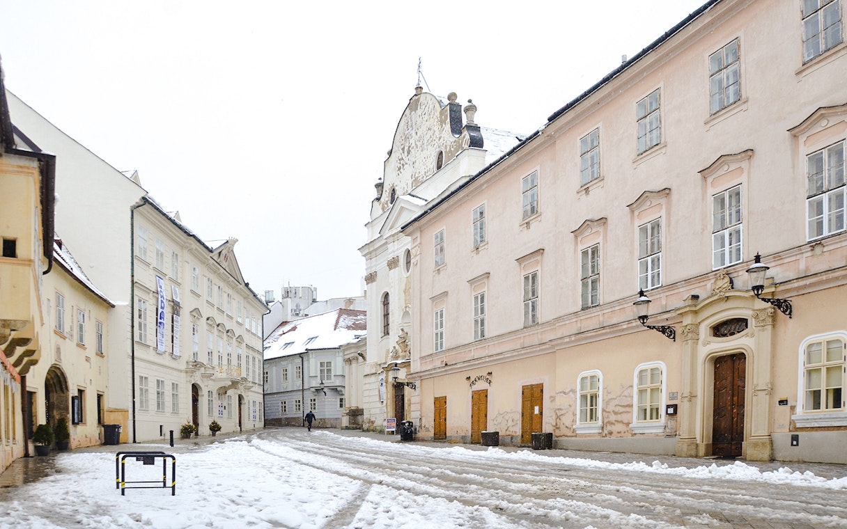 Old Town Hall in Bratislava covered in snow during winter.
