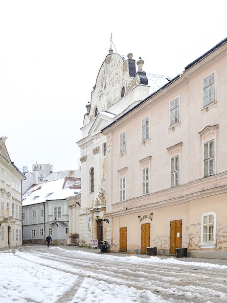 Old Town Hall in Bratislava covered in snow during winter.