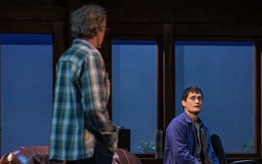 Two people in conversation in a dimly lit room, McNEAL context.