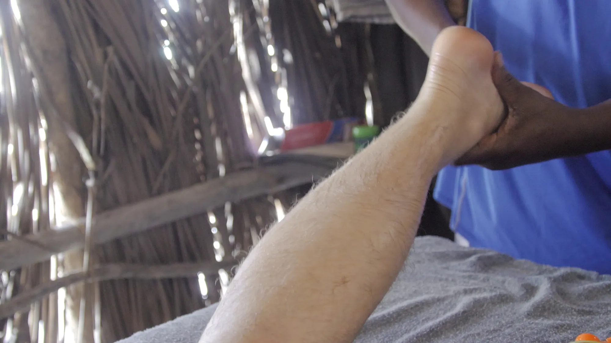 Foot massage in a traditional setting at Diani Beach.