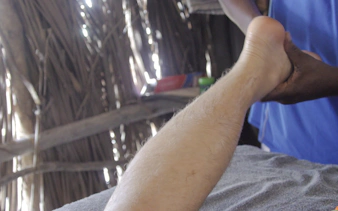 Foot massage in a traditional setting at Diani Beach.