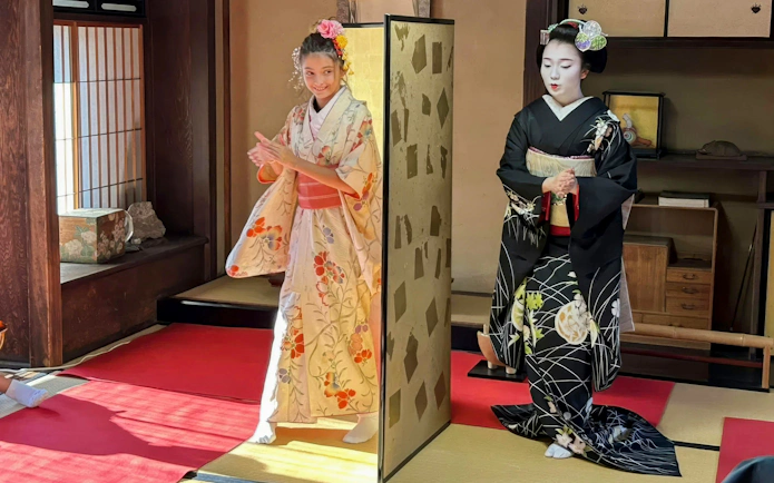 Geisha and Maiko performing traditional dance in Kyoto tea house.