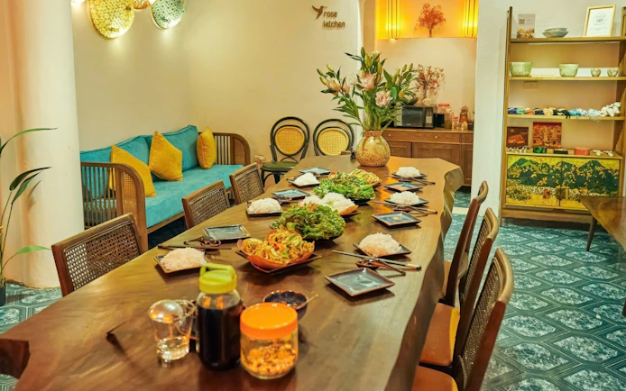 Traditional Vietnamese cooking class setup with dishes and ingredients on a wooden table.