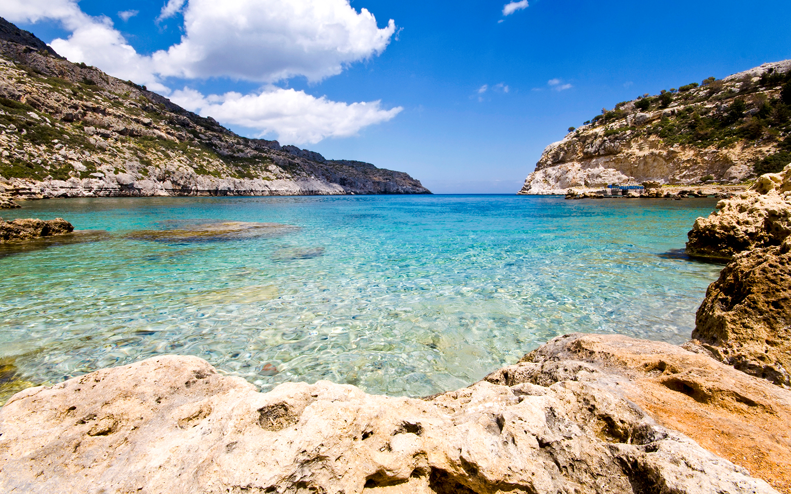 Clear waters and rocky coastline at Ladiko Beach, Rodos Island, Greece.
