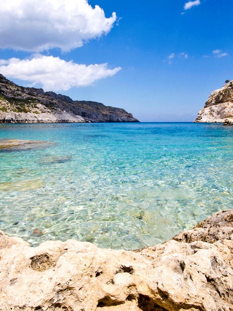 Clear waters and rocky coastline at Ladiko Beach, Rodos Island, Greece.