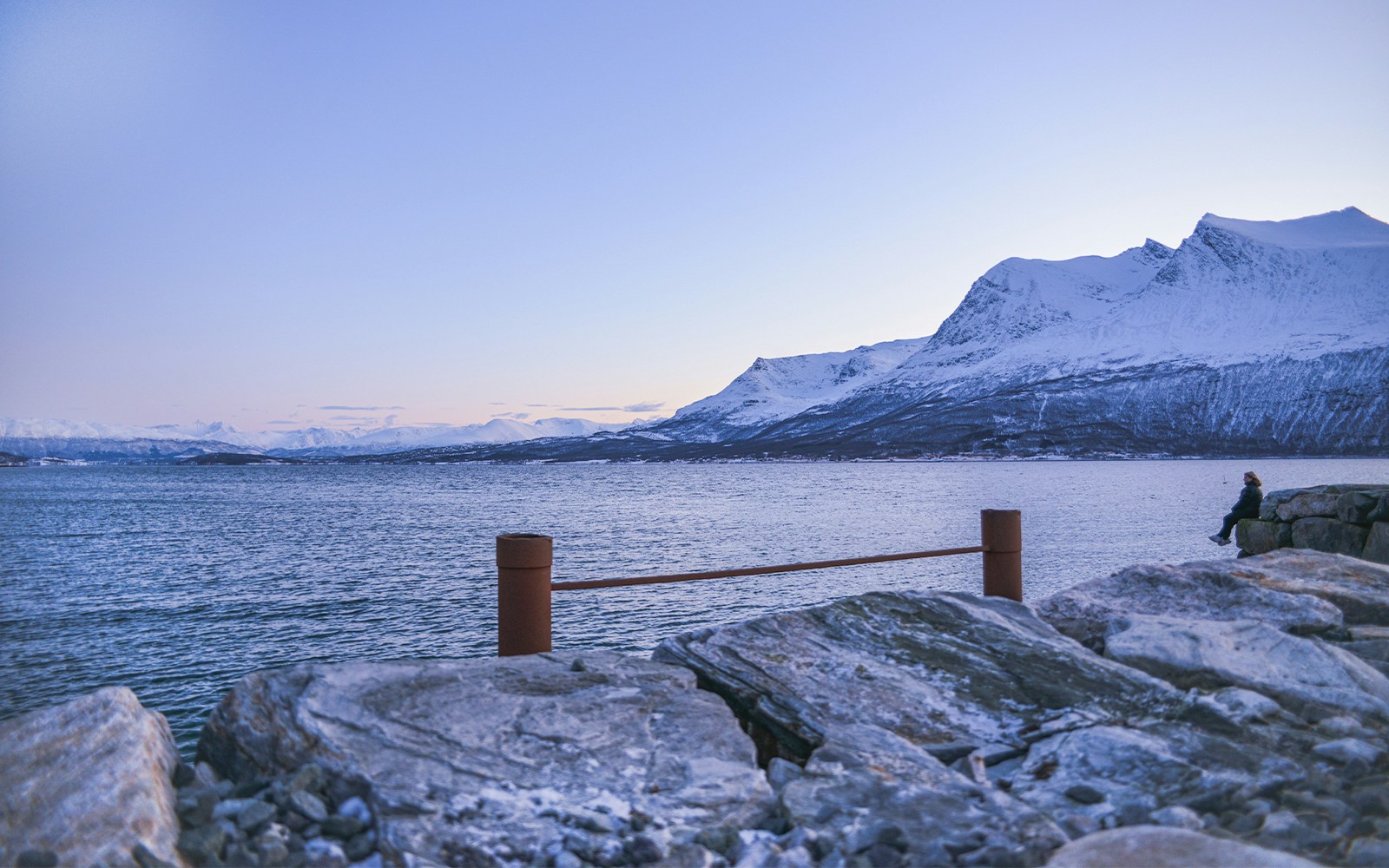 View of snowy mountains and bridge from Kvaloya island, Norway.