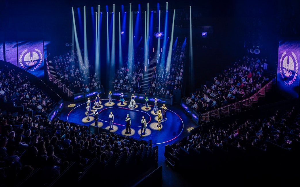 Hunger Games West End show stage performance with actors in spotlight.