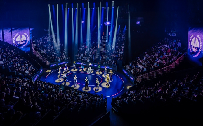 Hunger Games West End show stage performance with actors in spotlight.