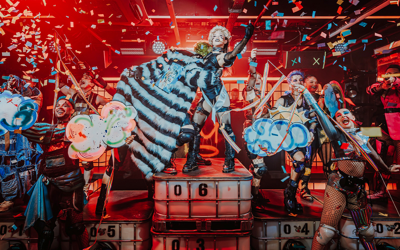 Performer on stage with colorful confetti at Oscar at the Crown show.