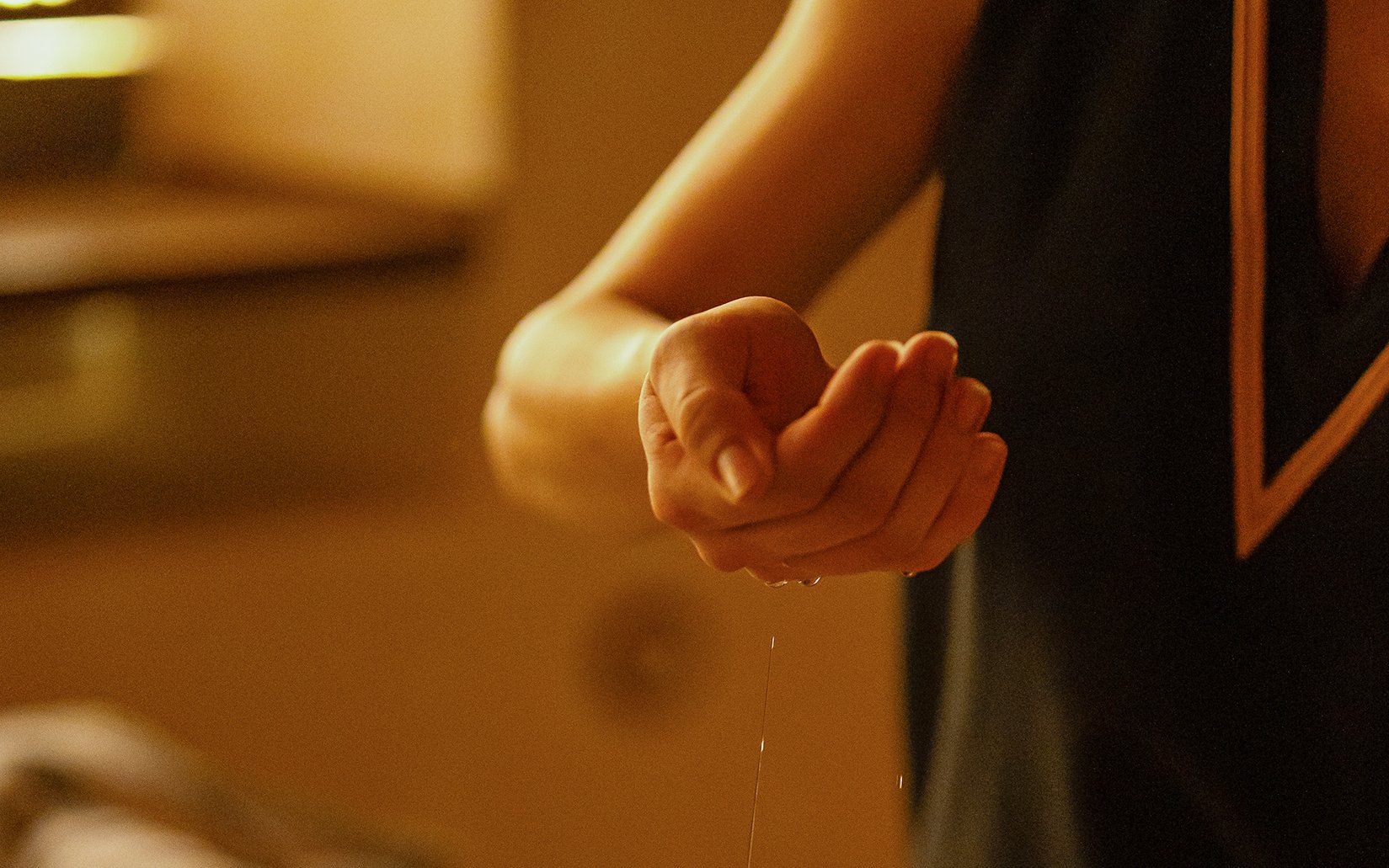 Massage therapist applying oil during Traditional Hammam in Granada.