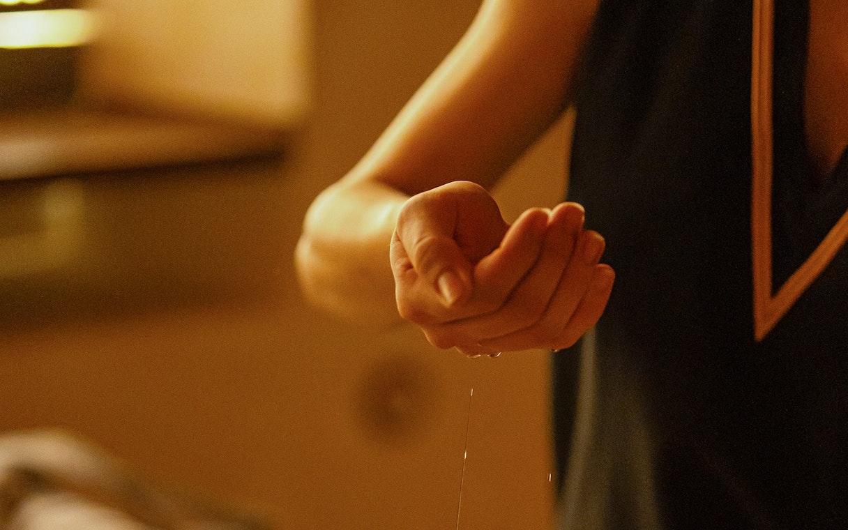 Massage therapist applying oil during Traditional Hammam in Granada.