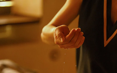 Massage therapist applying oil during Traditional Hammam in Granada.