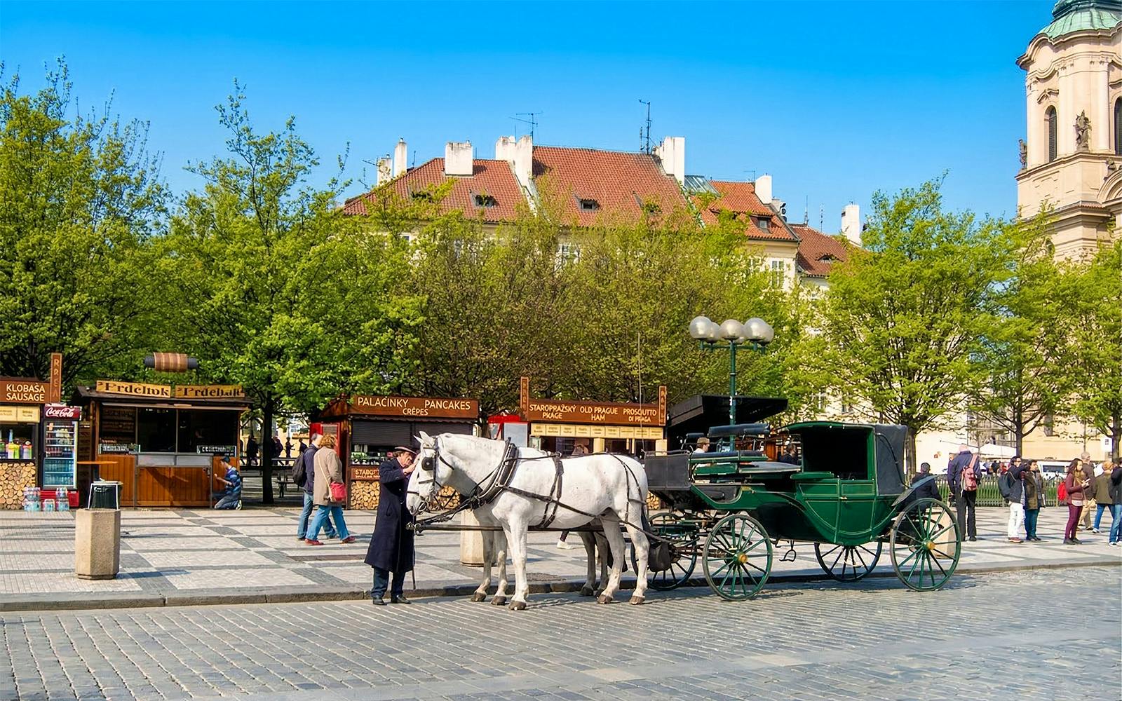 Horse-drawn carriage in Prague's Old Town Square during walking tour.