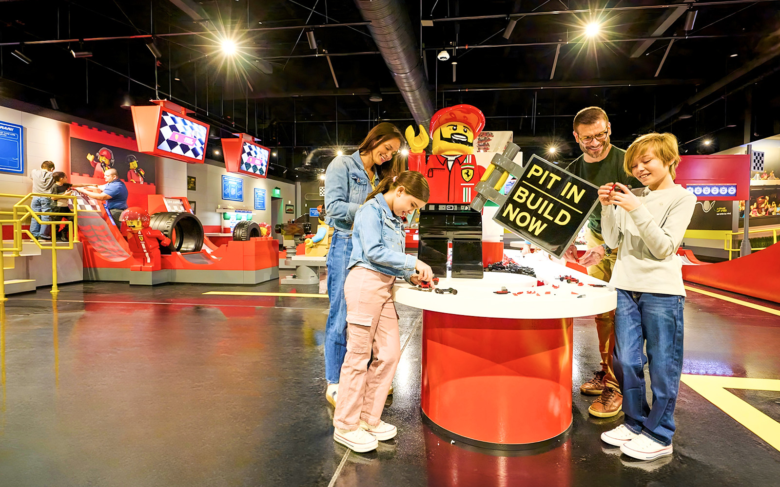 Guests building Lego cars at Ferrari garage zone, Legoland New York.