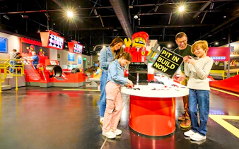 Guests building Lego cars at Ferrari garage zone, Legoland New York.