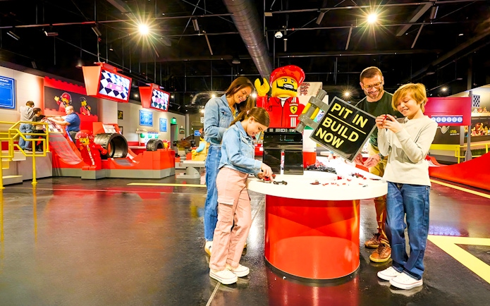 Guests building Lego cars at Ferrari garage zone, Legoland New York.