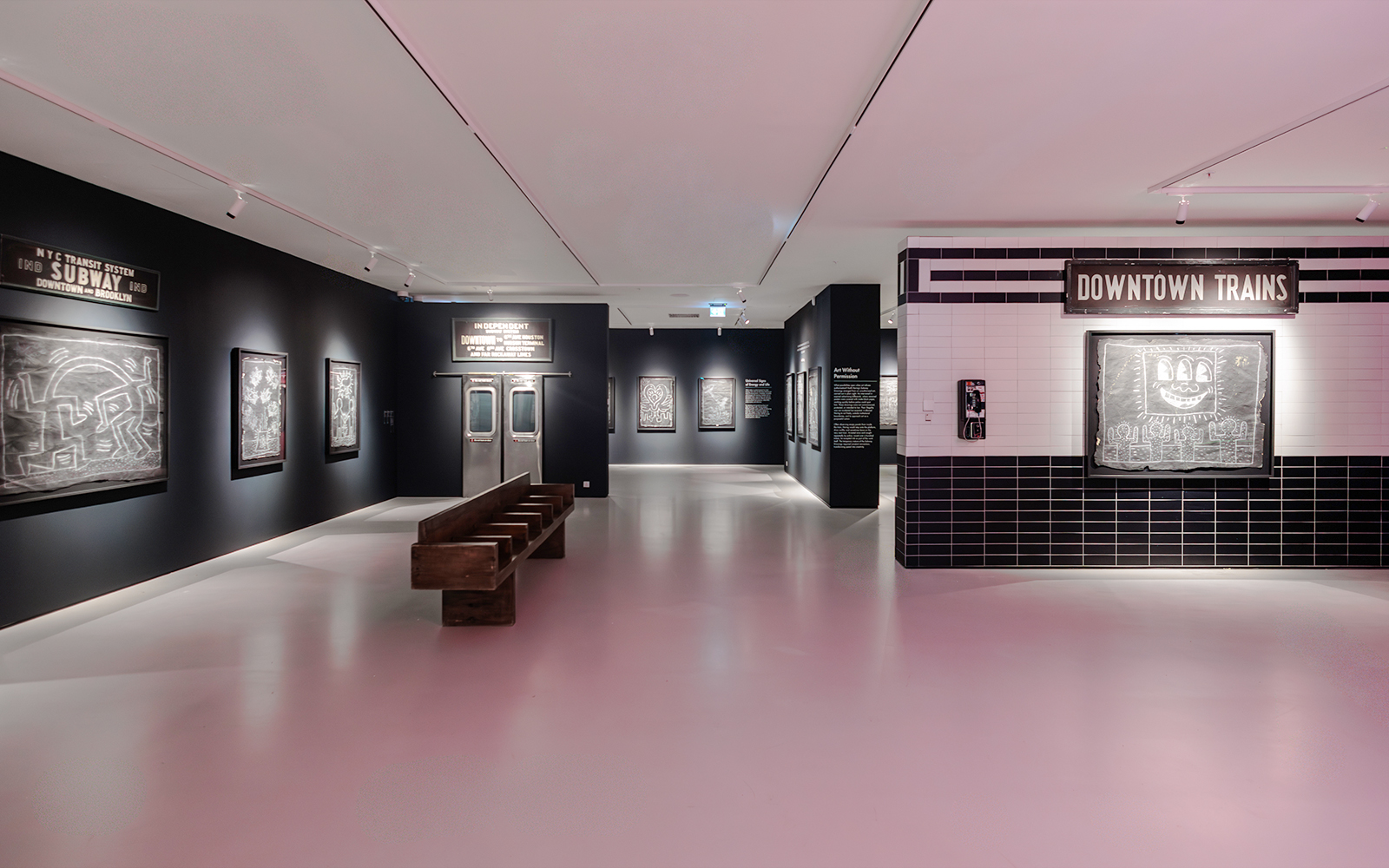 Keith Haring artworks in subway-themed room at Moco Museum London exhibit.