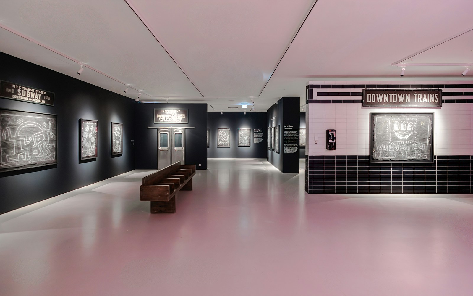 Keith Haring artworks in subway-themed room at Moco Museum London exhibit.