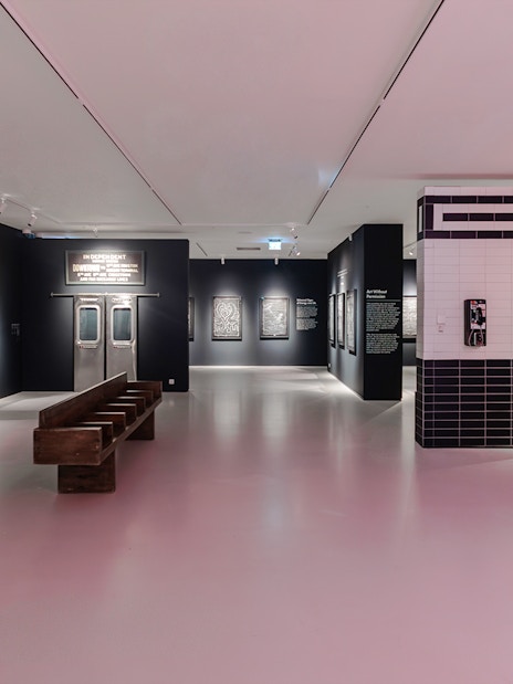 Keith Haring artworks in subway-themed room at Moco Museum London exhibit.