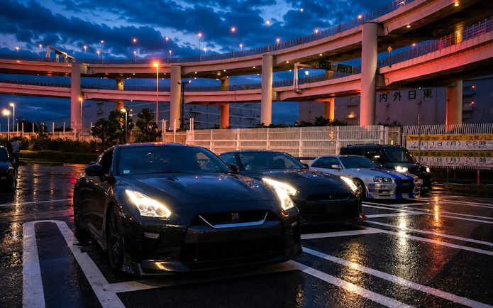 Cars parked at Daikoku PA under illuminated highway, Tokyo Drift JDM Culture Tour.