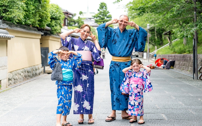 Guests in kimonos posing at Kyoto Kimono Rental, Japan.