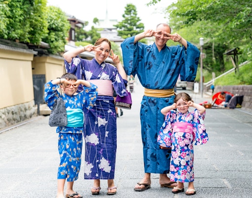 Kimono-clad individuals walking through Gion district, Kyoto, during full-day rental experience.